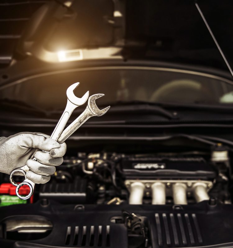 Mechanic holding the wrench to repairing car engine problem.