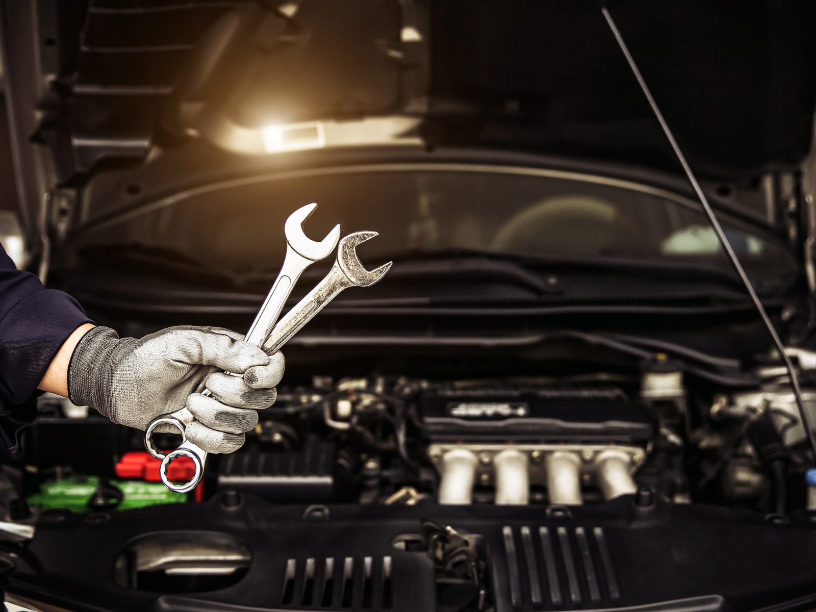 Mechanic holding the wrench to repairing car engine problem.